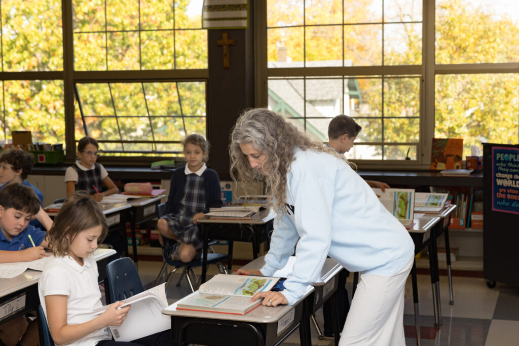 Catholic school teacher instructing students in classroom
