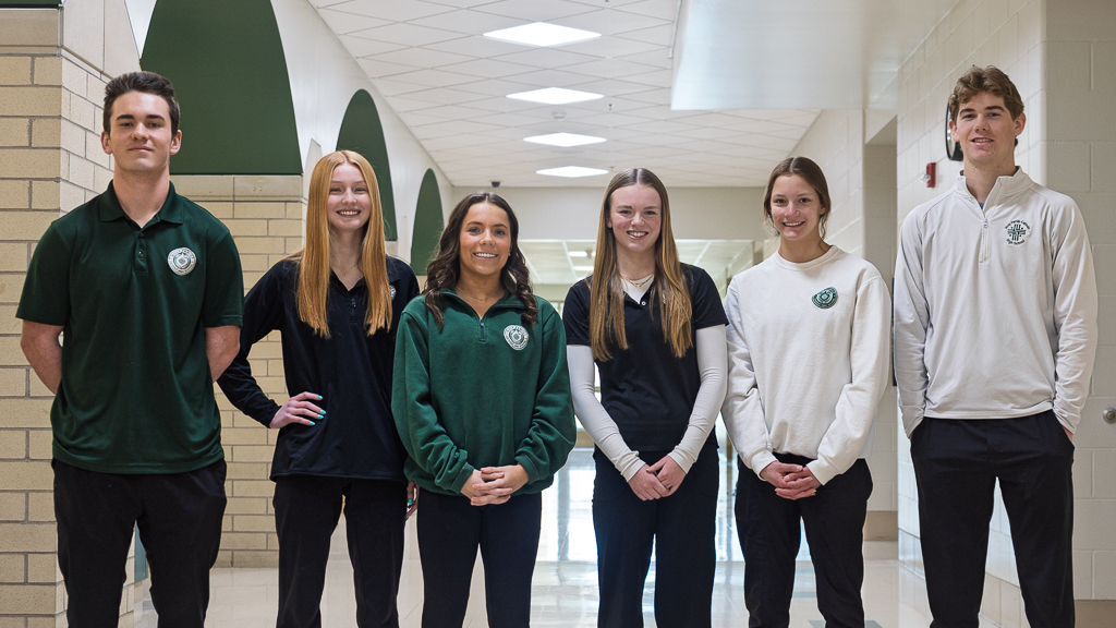 Catholic high school students smiling in a hallway