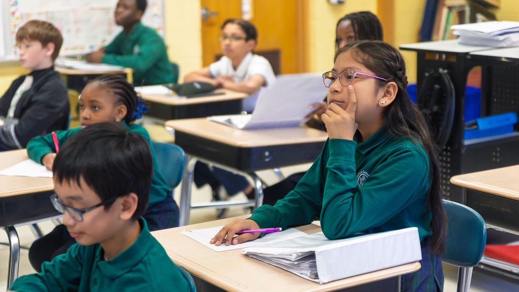Catholic school students learning in a classroom