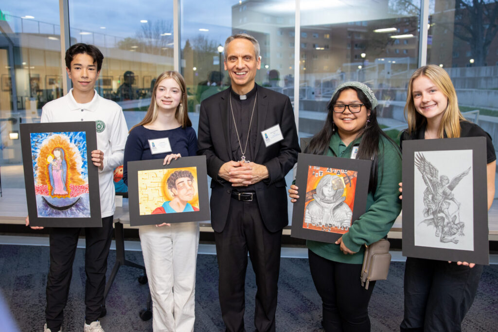 Bishop Michael Izen with Catholic school students at Visual Arts Exhibition in Saint Paul