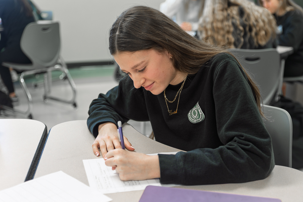 Catholic high school student working at desk